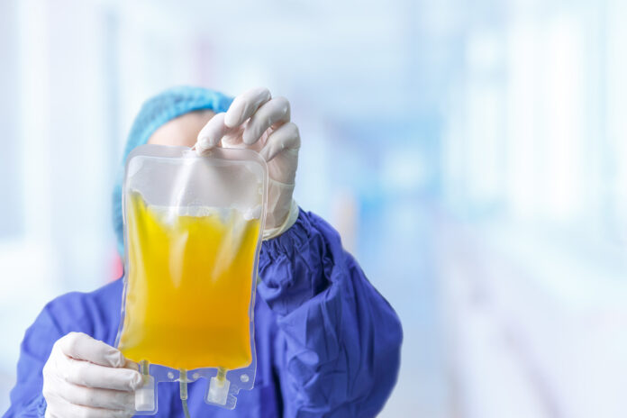 Gloved,Hands,Of,A,Medical,Professional,Holding,A,Bag,Of
