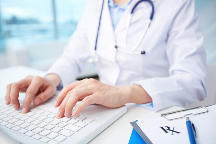 Modern,Medical,Person,Inputting,Diagnosis,Into,An,Online,Data,Base